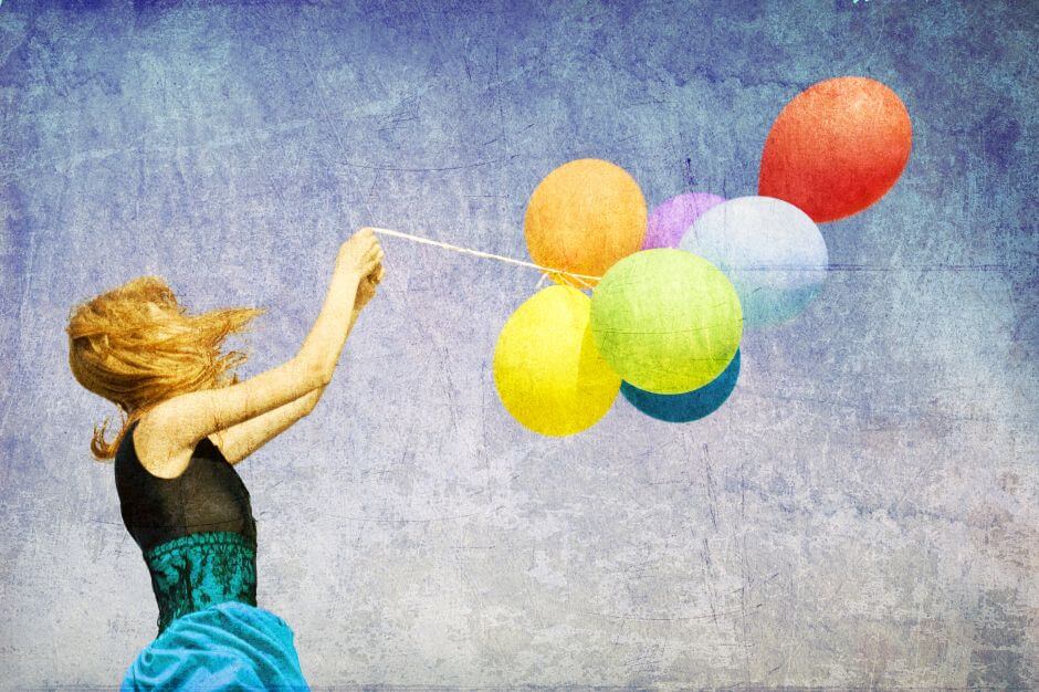 woman holding balloons in the wind