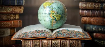 Old,Globe,Lying,On,An,Open,Book,In,A,Library.